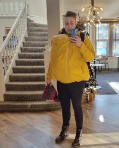 Parent wearing a babywearing coat with a baby inside
