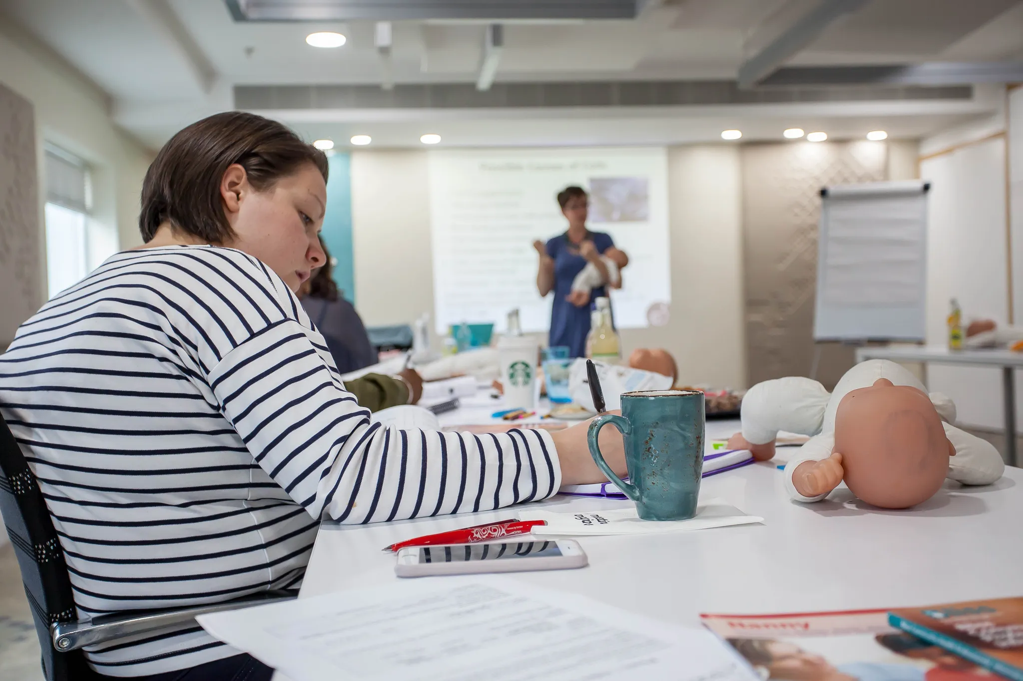 A Babyem maternity nurse training cohort in London, with the trainer teaching at the front of the room